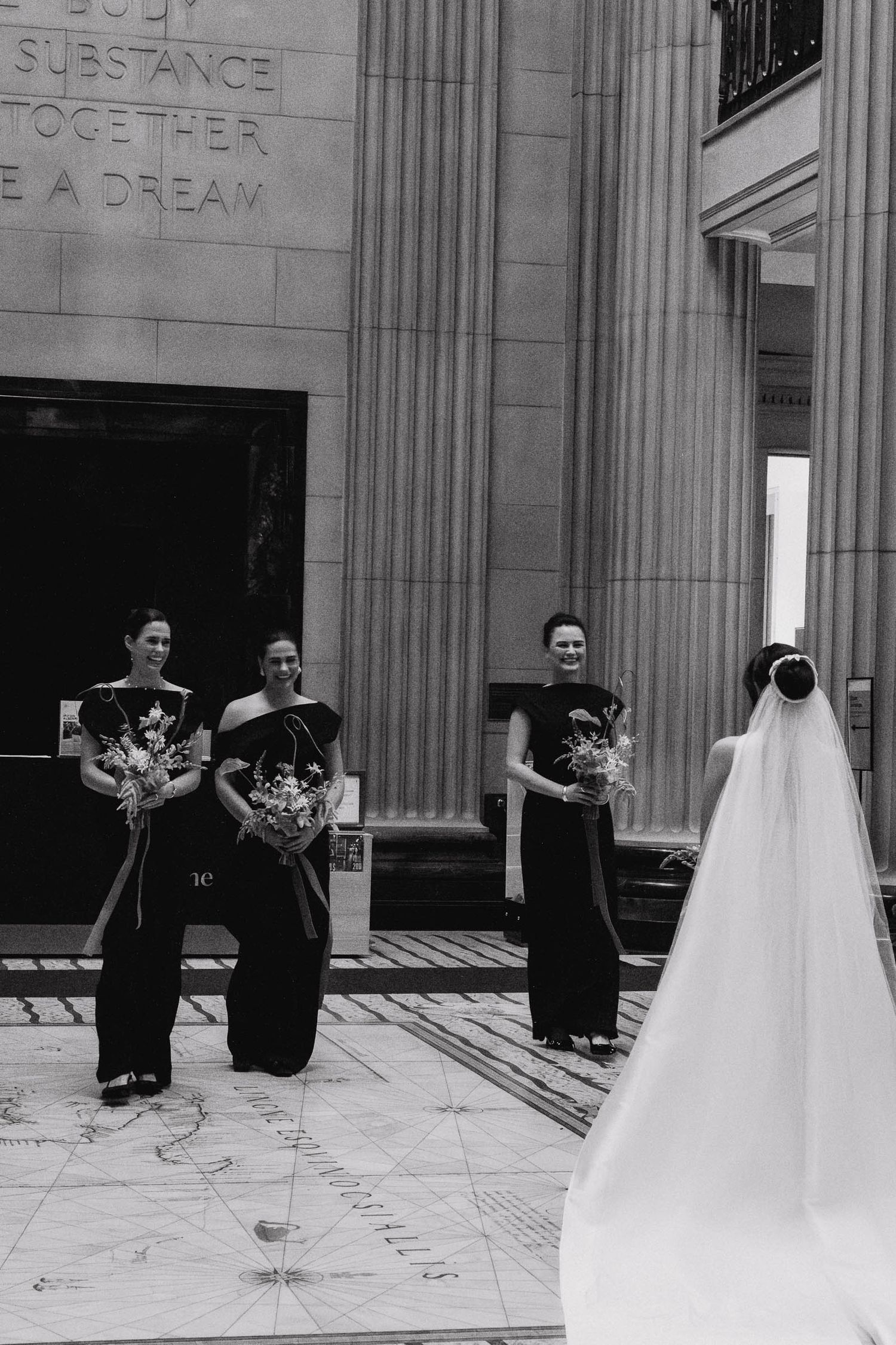 A series of black and white photos showing a couple in wedding attire dancing playfully outside a columned building.