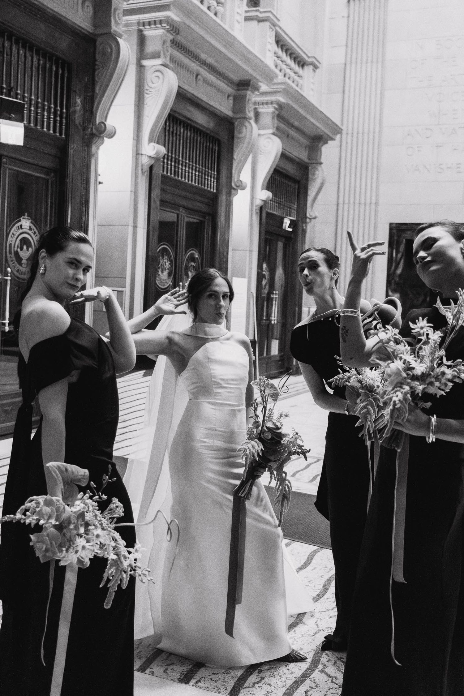 A sequence of black and white wedding photos showing a couple posing with flowers and formal attire outside a building.
