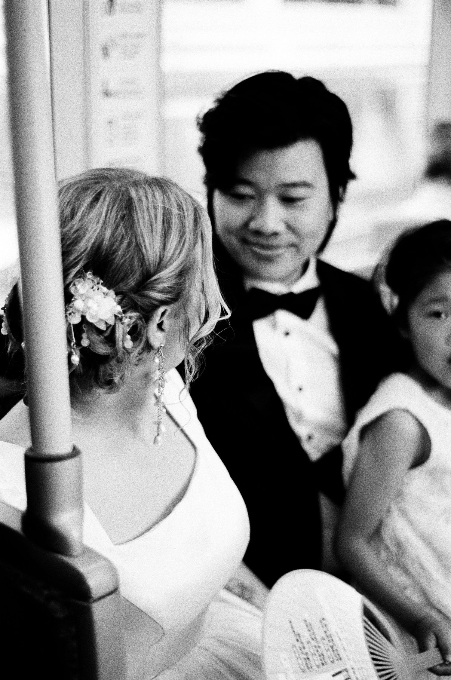 Black and white wedding photo showing an intimate moment between newlyweds during their reception celebration.