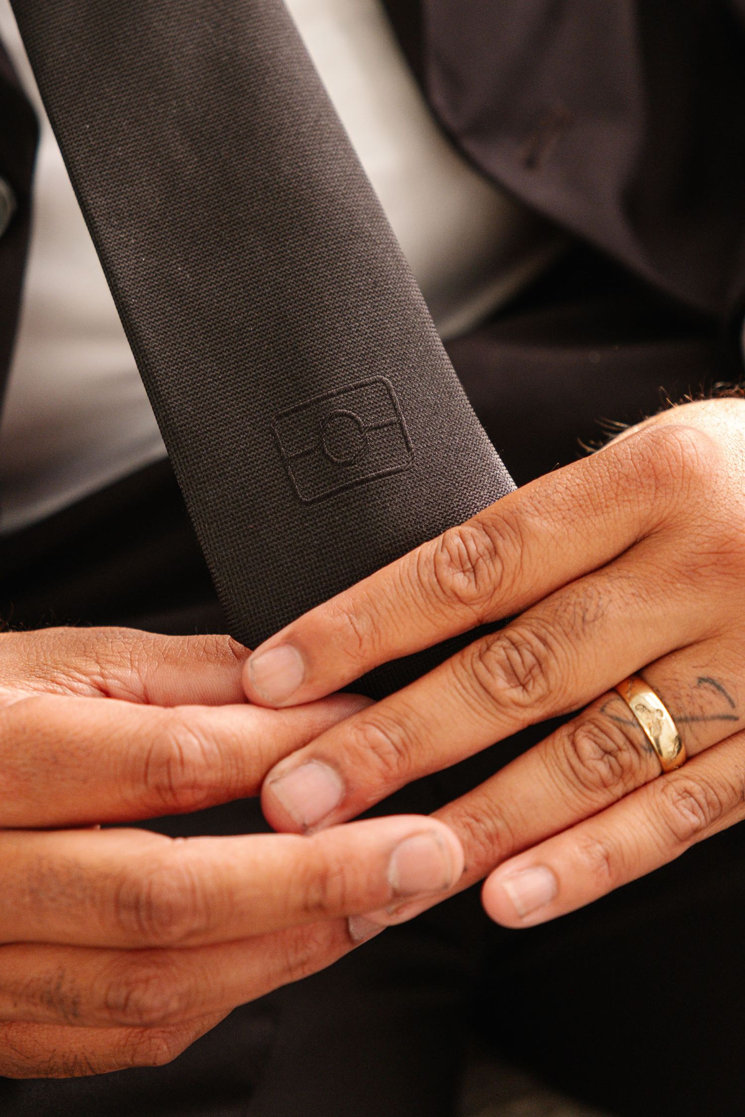 Close-up sequence of hands exchanging wedding rings during a ceremony.