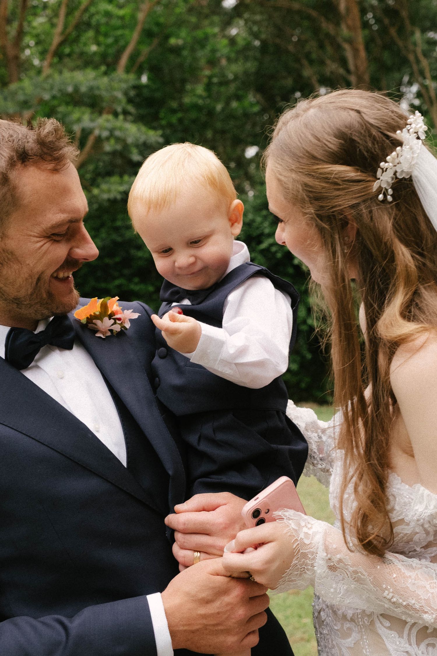 A sequence of tender moments between a couple and child in formal attire at a wedding celebration.