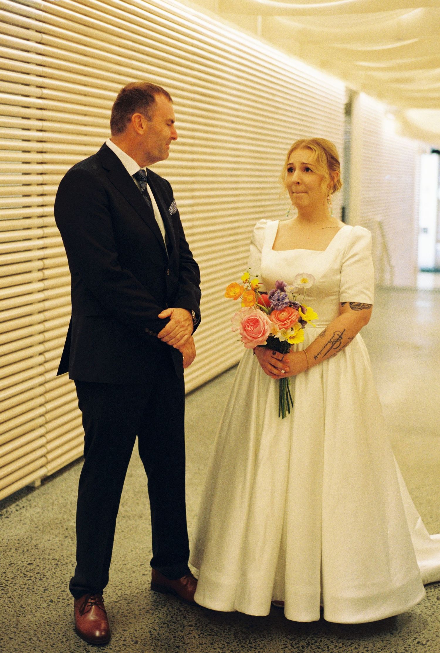 A series of wedding photos showing a couple in formal attire sharing a tender moment in a hallway with white blinds.