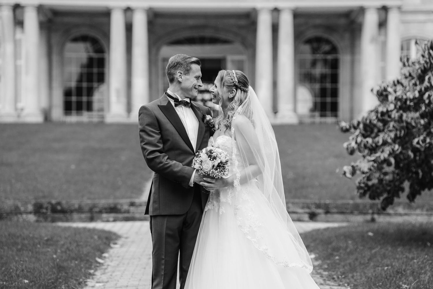 A romantic black and white wedding photo series showing tender moments between newlyweds on their special day.