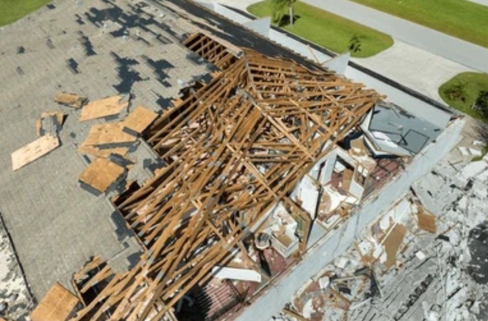 A drone photo of a damaged roof.