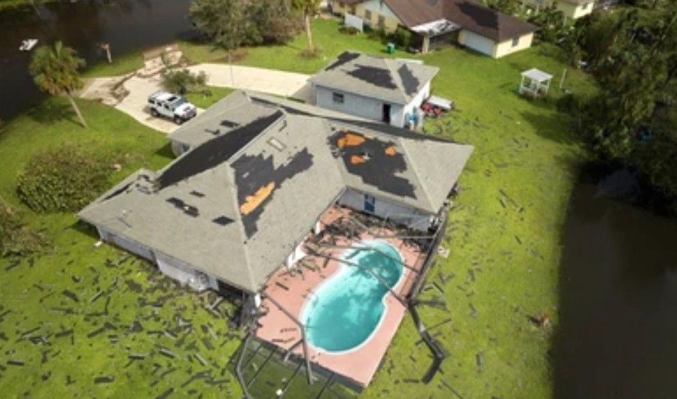 A drone photo of a damaged roof.