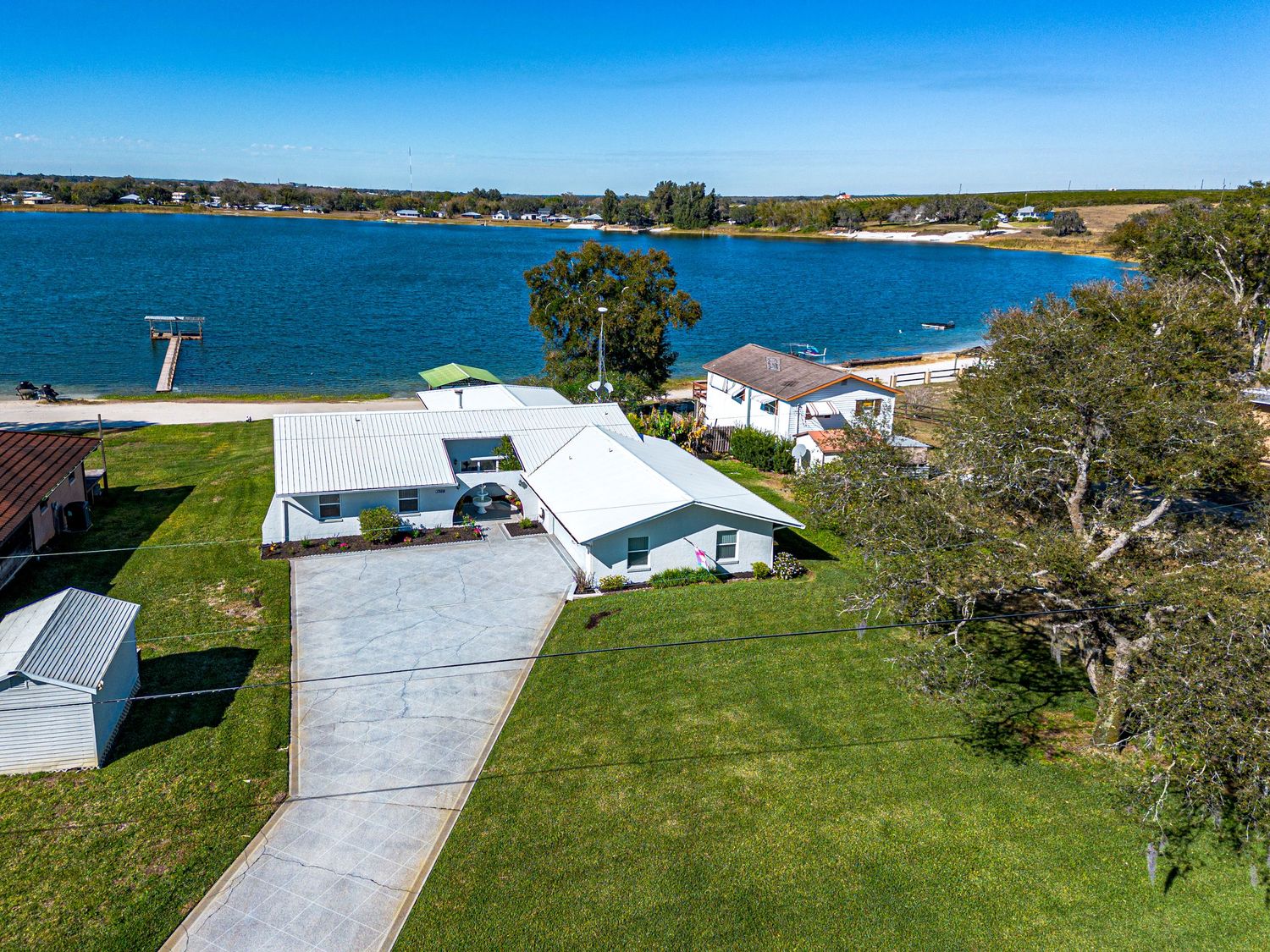 A drone photo of a house for sale on a lake in Frostproof, Florida