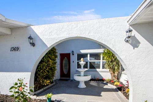 A picture of the front door of a house that is for sale.