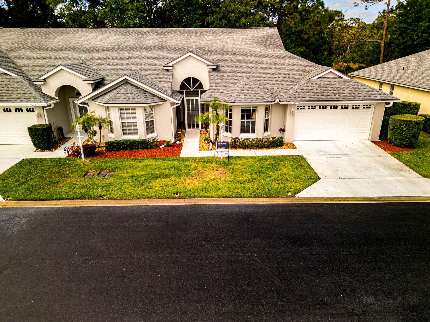 A drone photo of a house for sale.