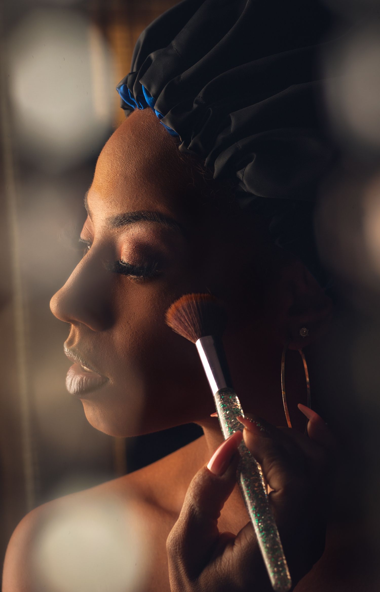 Artistic profile portrait silhouette sequence showing someone putting on makeup with dramatic lighting and shadows.