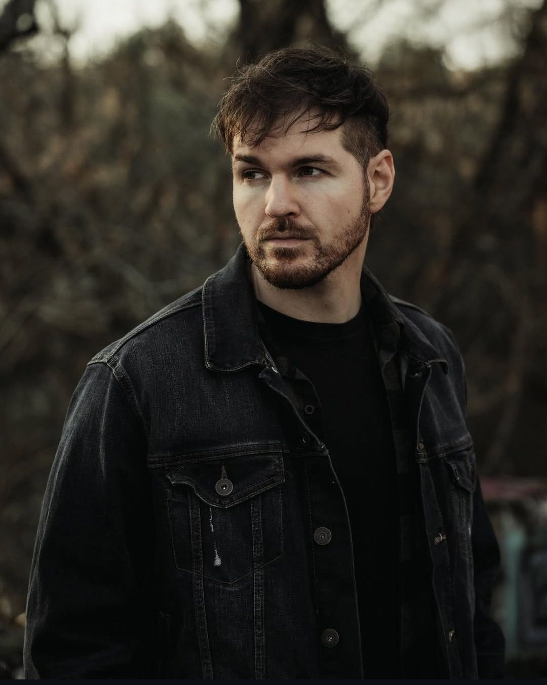A person in a dark denim jacket poses against a moody outdoor background in a series of connected portrait shots.