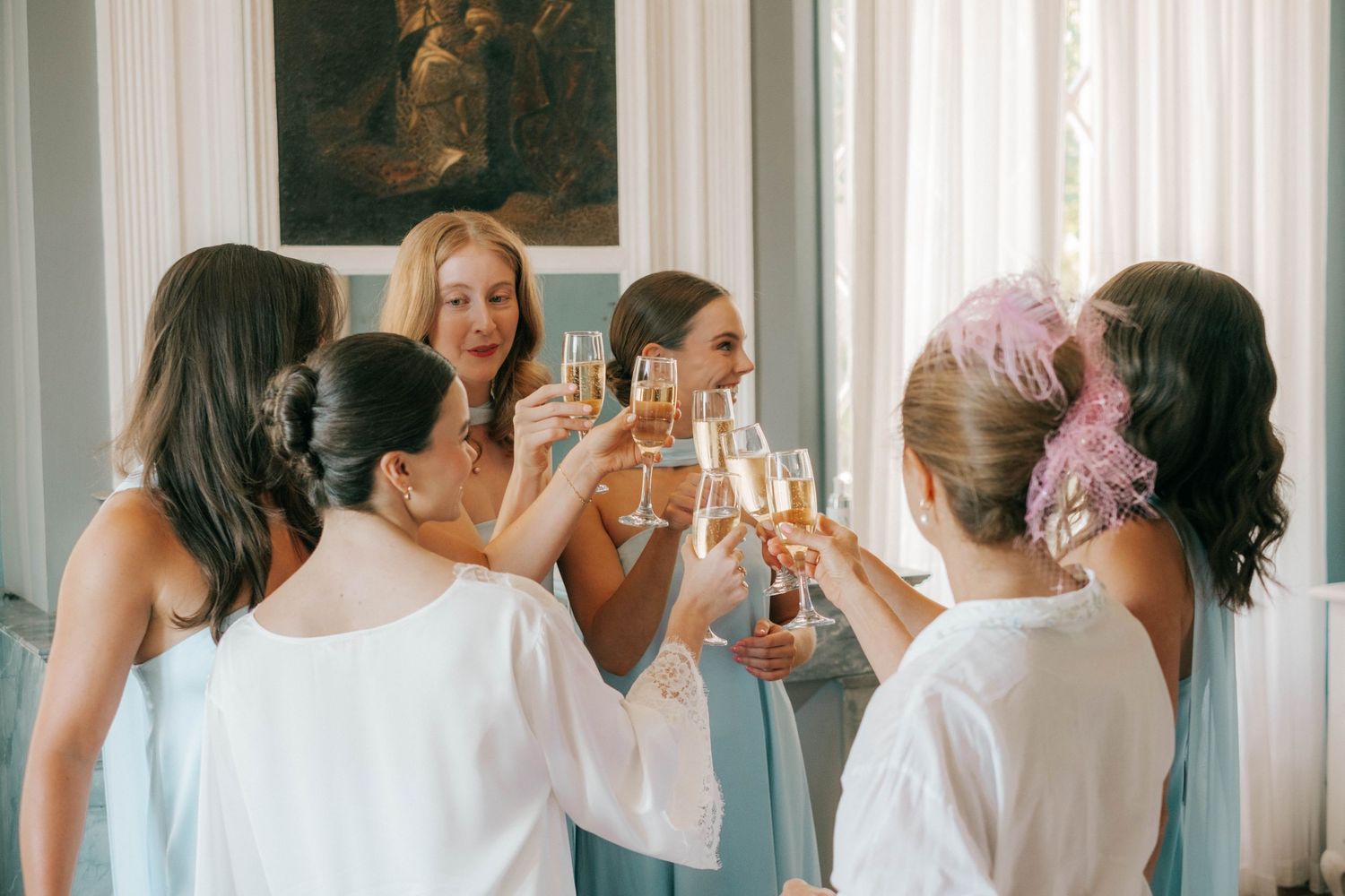 Bride and bridesmaids toasting with champagne during wedding morning preparations, Barcelona