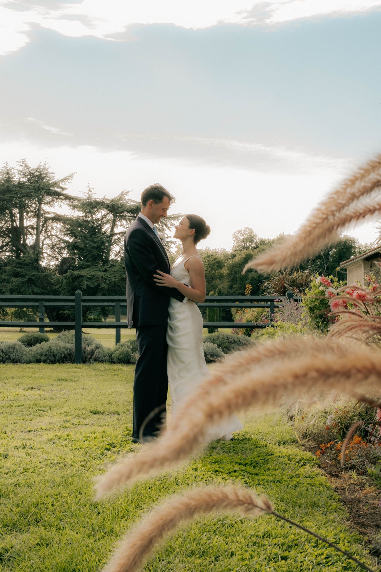 Bride and groom sharing an intimate moment in garden during golden hour, destination wedding Spain.