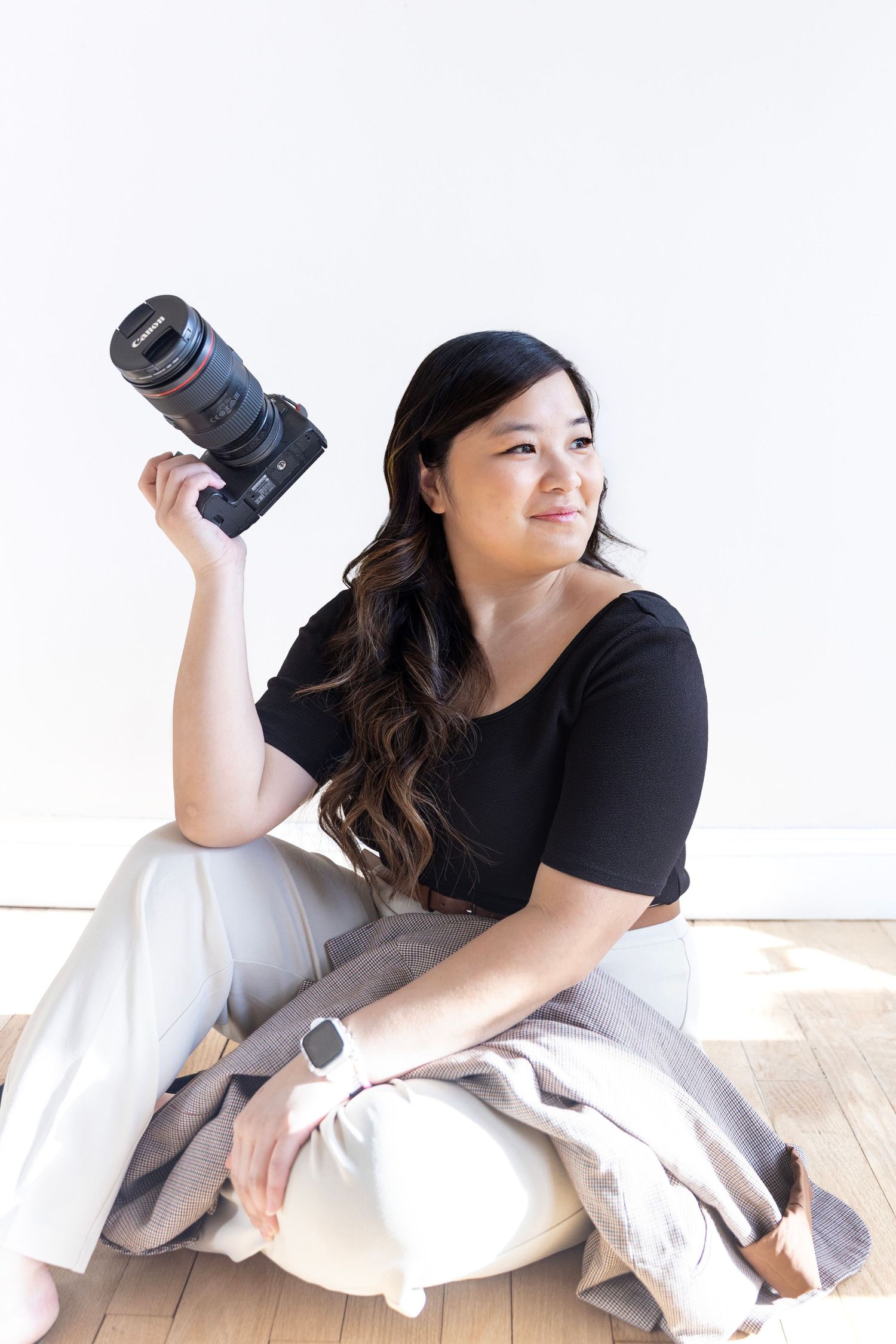 The woman behind LivingFlow smiling during a photography studio session.