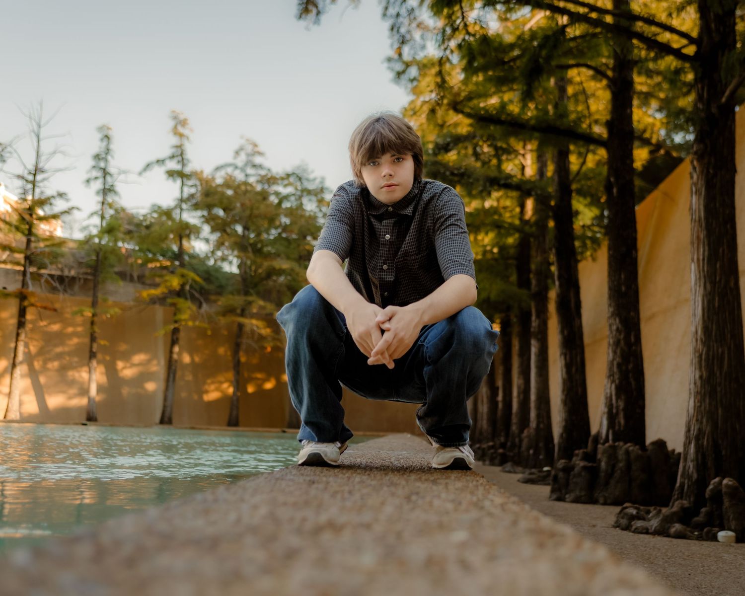 boy posing for Senior Portrait in Fort Worth Water Gardens