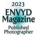 A teal and black logo for ENVYD Magazine with 'Published Photographer' text underneath against a white background.