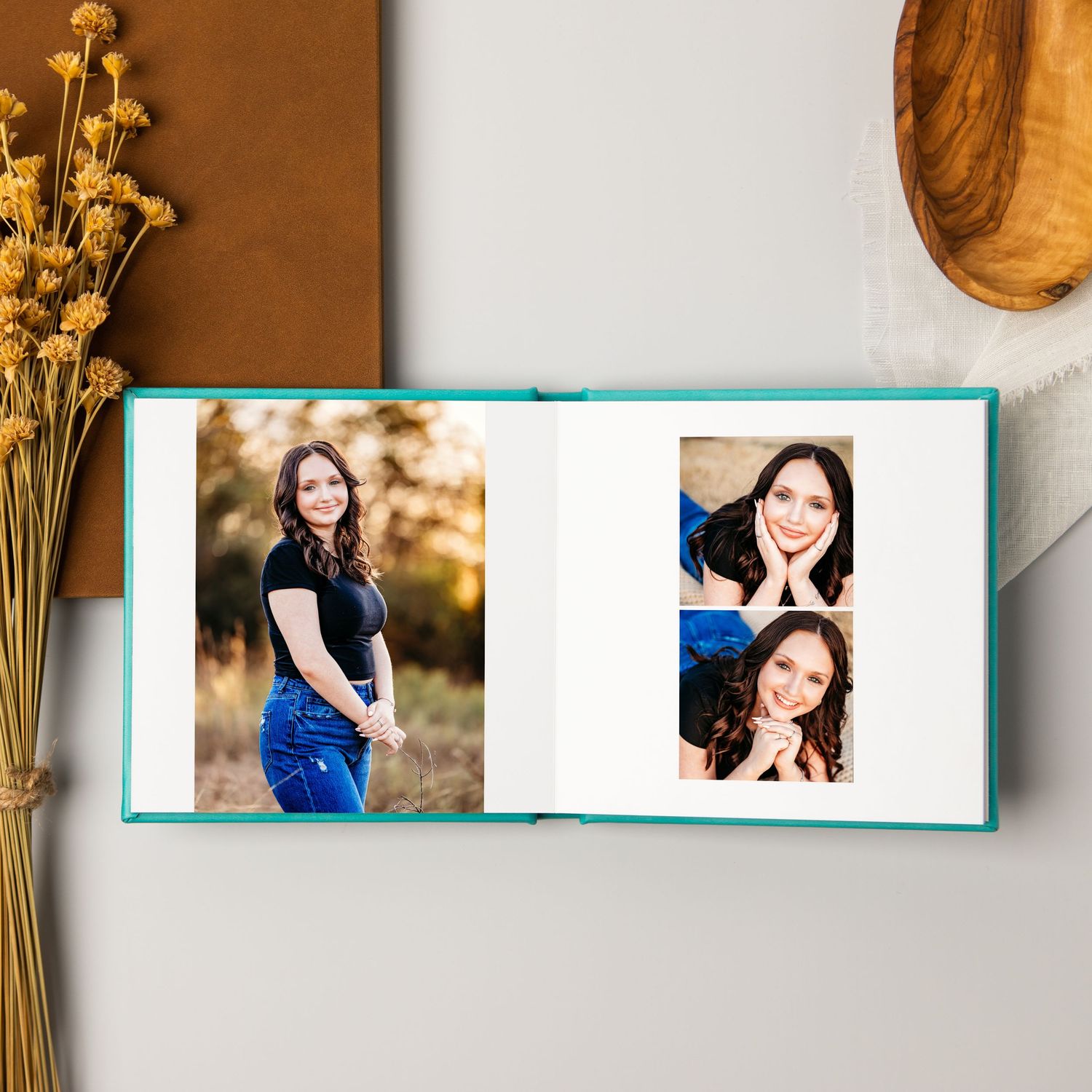 Gorgeous custom photo album with turquoise cover displaying senior portraits in Fort Worth, TX.