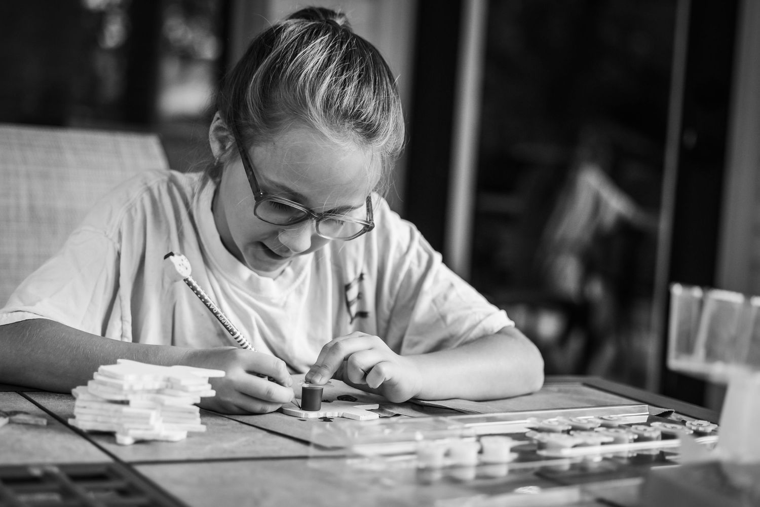Black and white photos showing students writing and studying at their desks in a classroom setting.