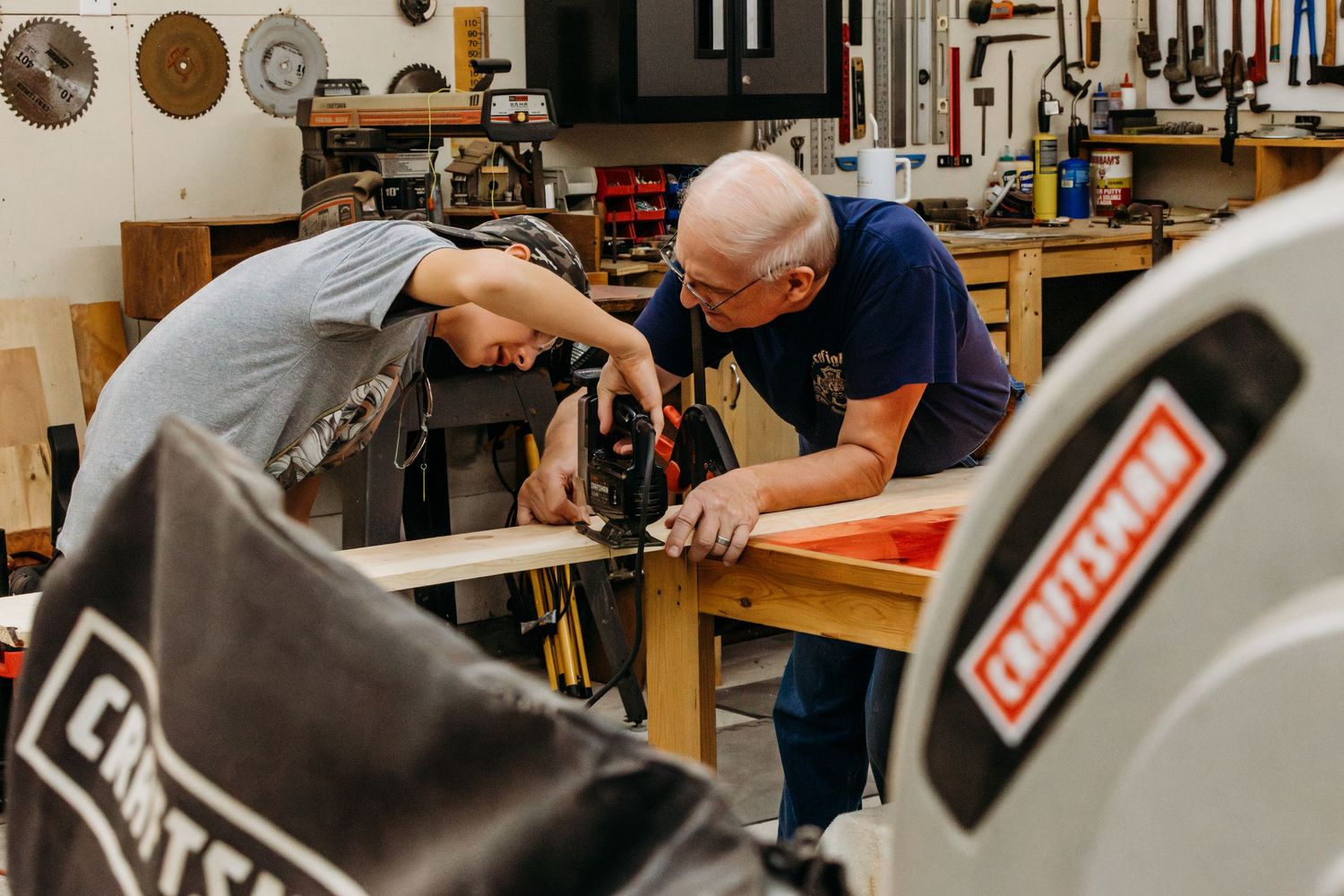 Tools and workshop equipment on display in a woodworking studio with equipment and machinery visible.