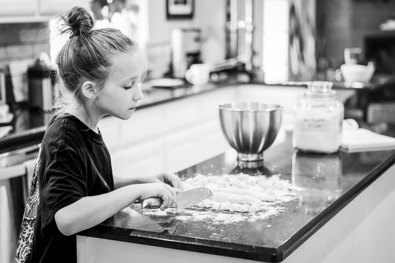 A child makes pasta from scratch