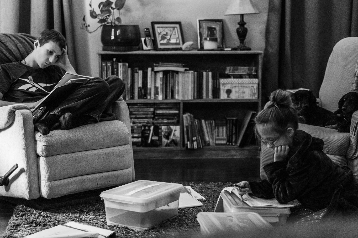black and white images of children doing schoolwork in their home