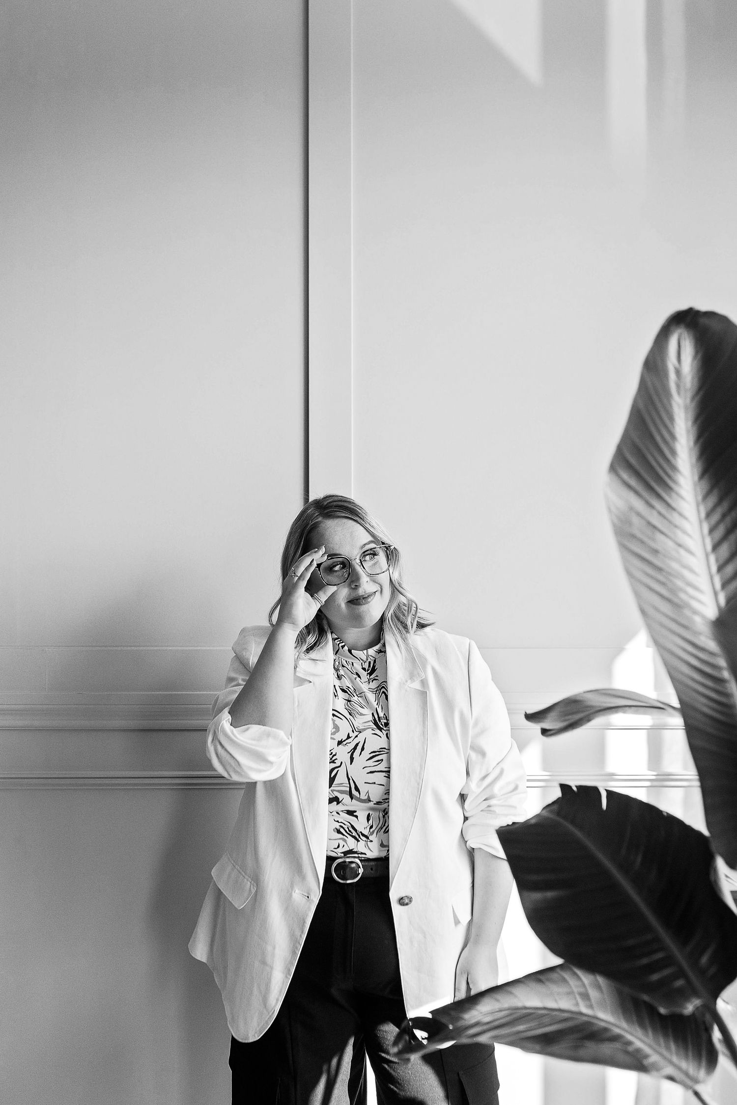 A series of black and white photos showing someone in a white lab coat making expressive poses against a light background.