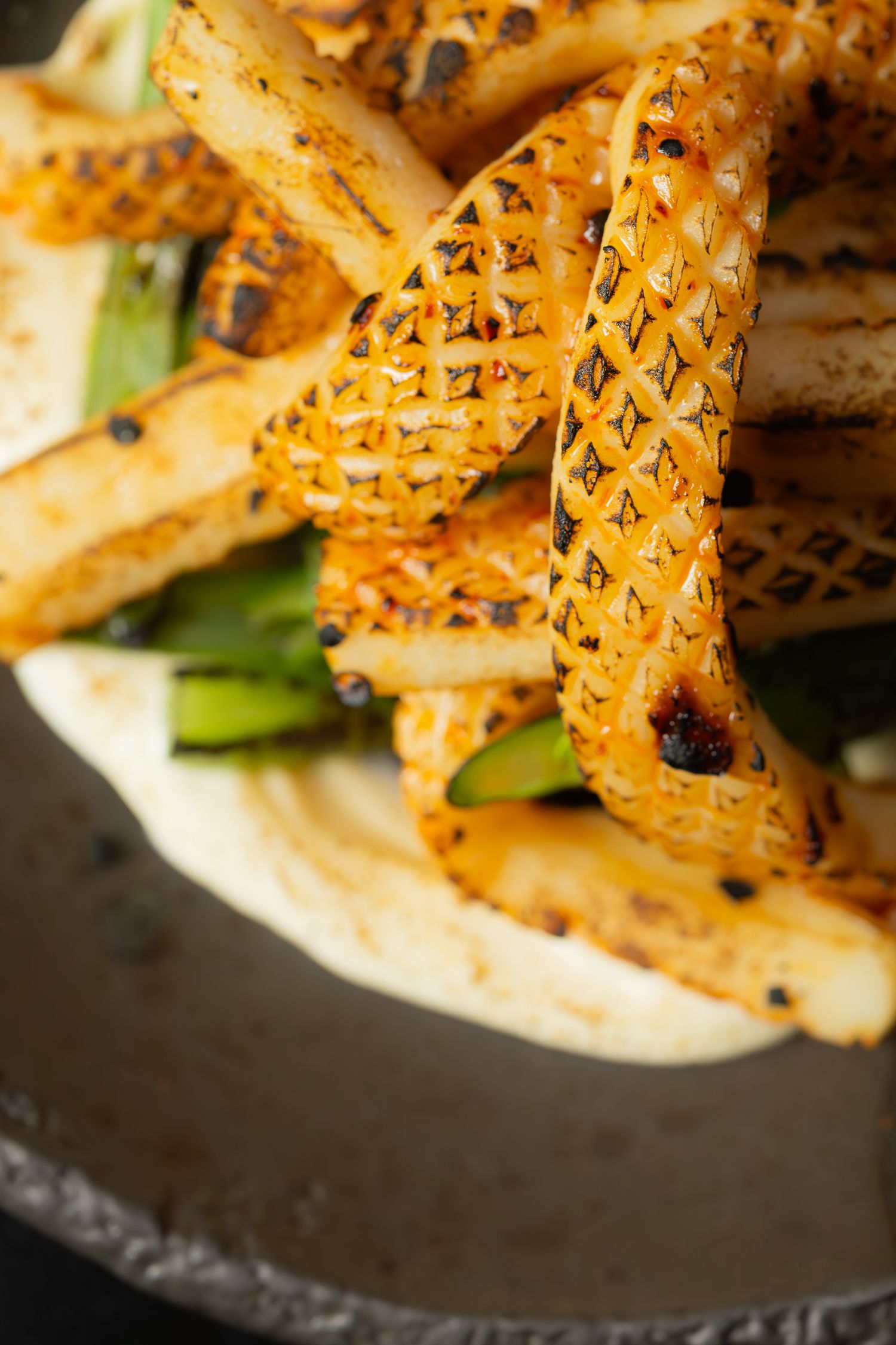 Close-up of golden latticed pastry strips with herbs and seasonings.