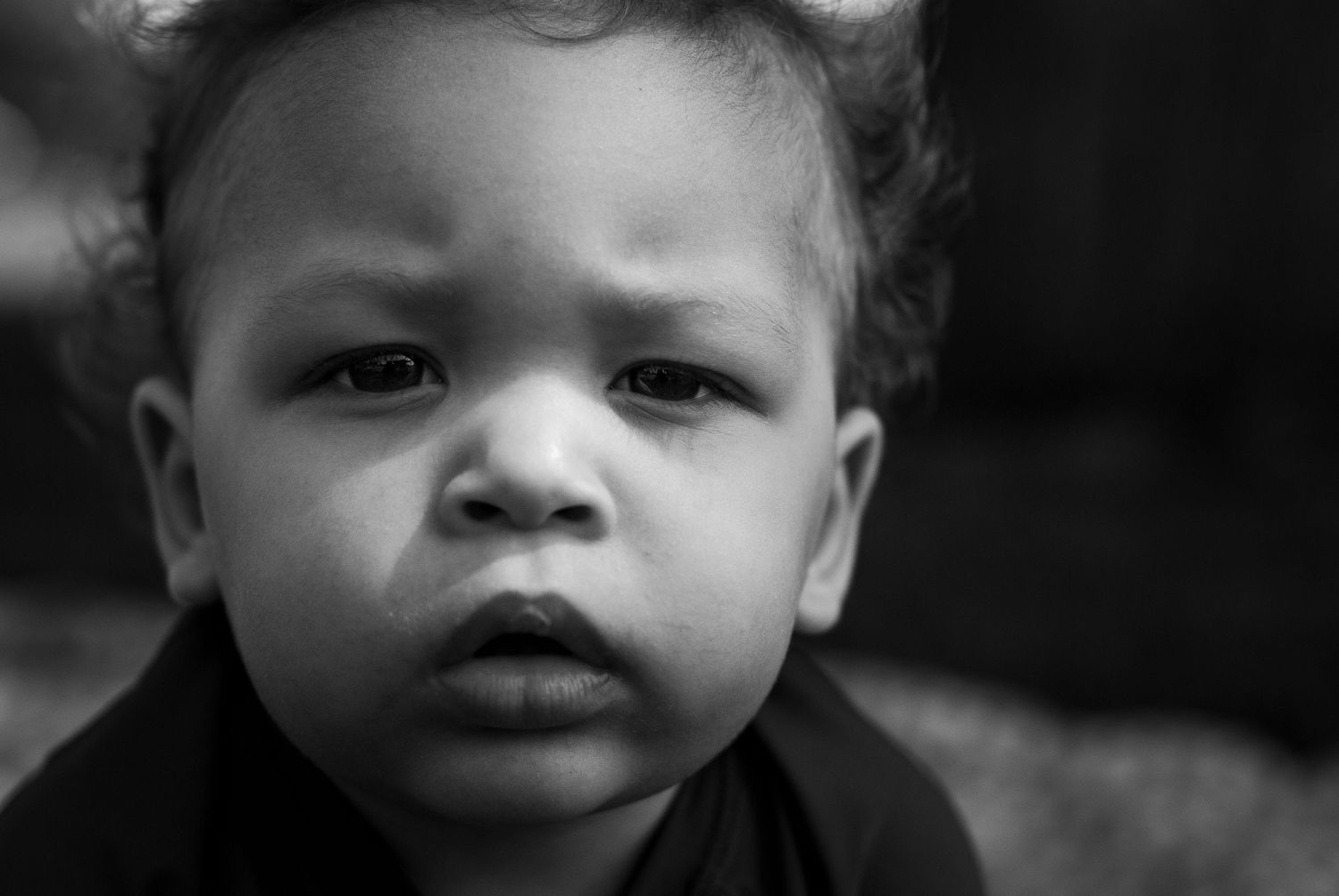 Black-and-white portrait of a toddler during a first birthday photography session in Elmira, NY