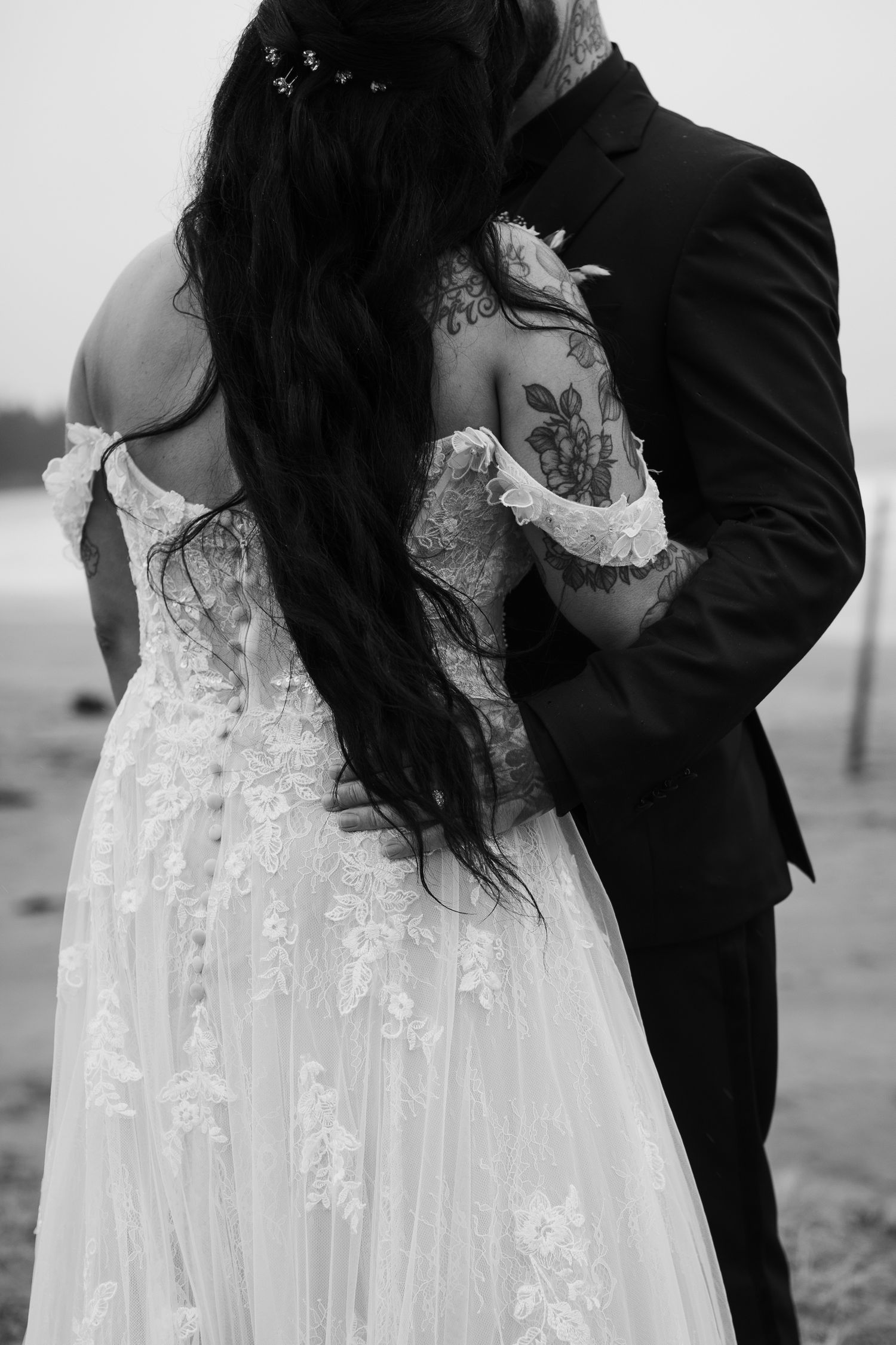 black and white image of bride and groom on the beach