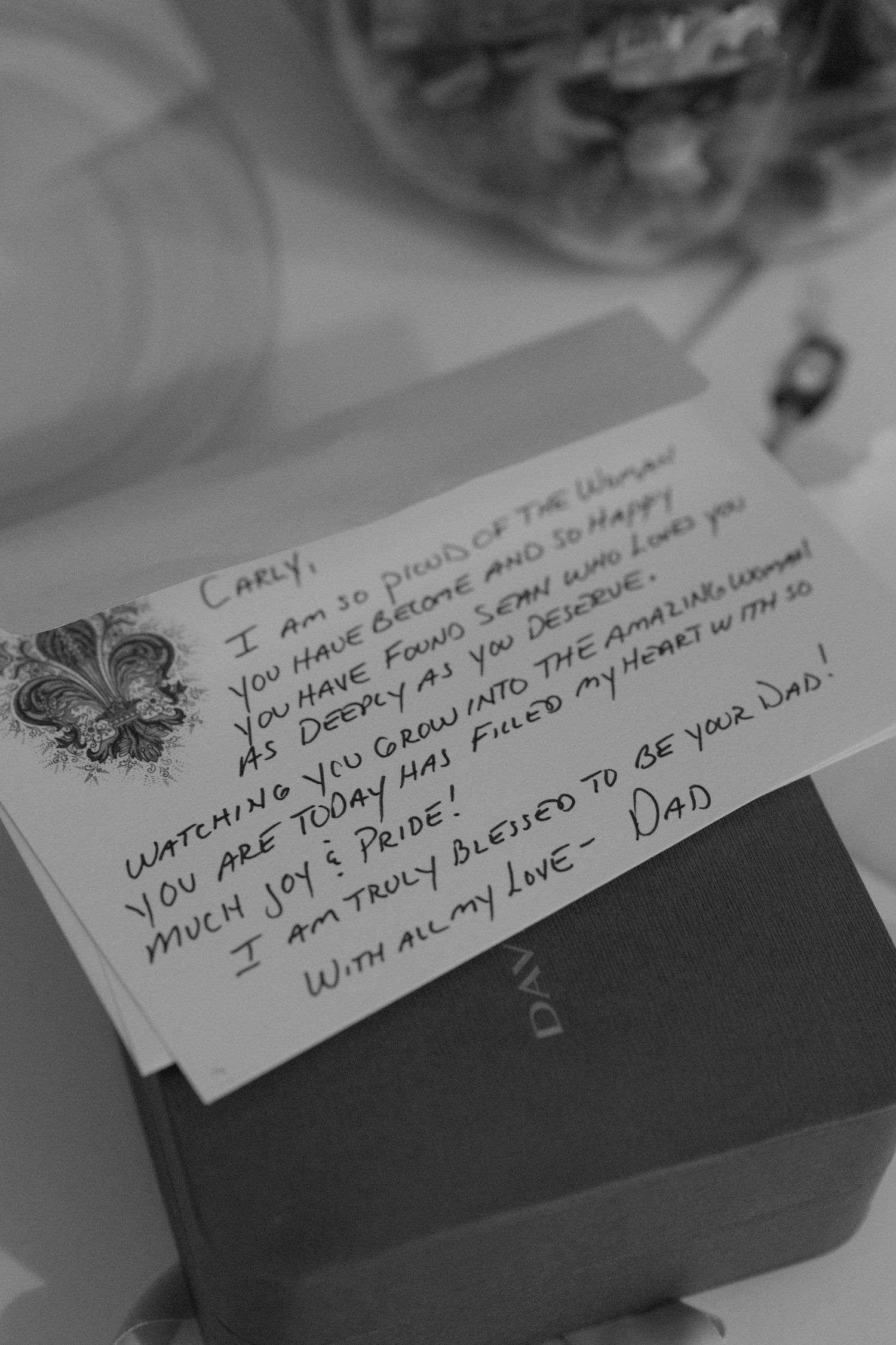 Handwritten note on paper captured in black and white photography.