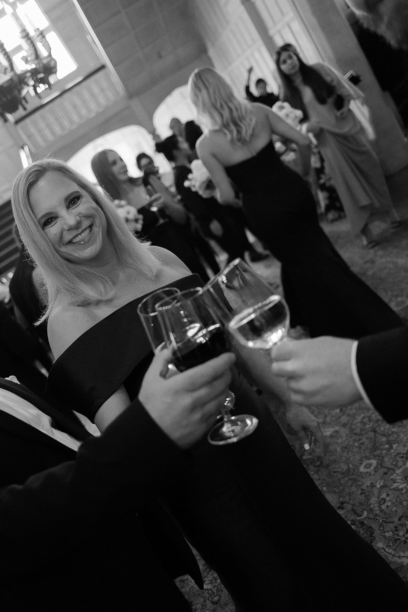 Black and white candid shots of guests enjoying drinks at an evening celebration.