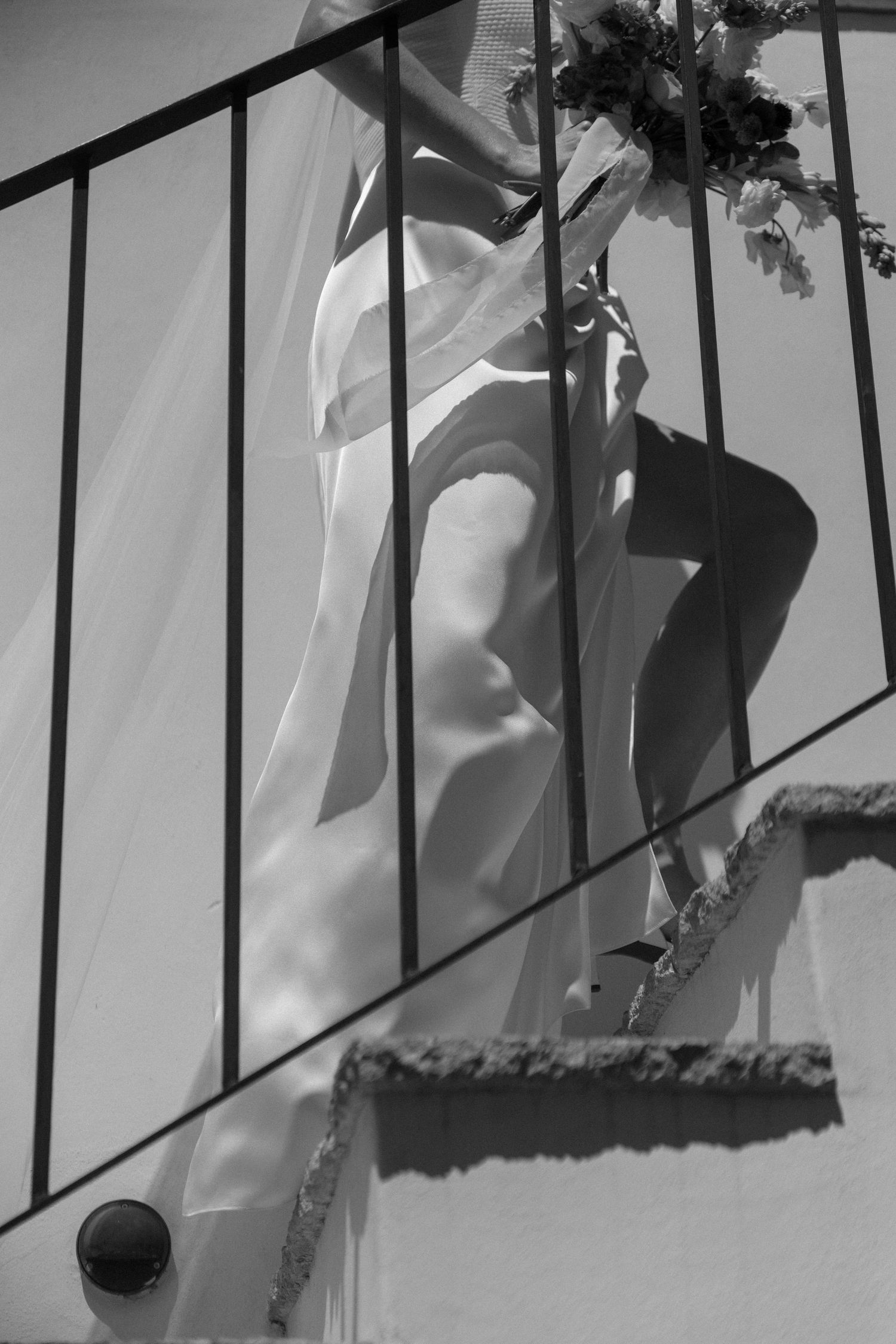 Black and white photos showing silhouettes through iron railings.