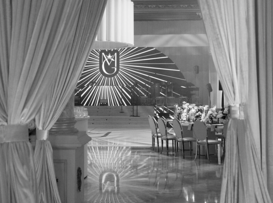 Modern wedding venue interior with dramatic white curtains and architectural lighting design.