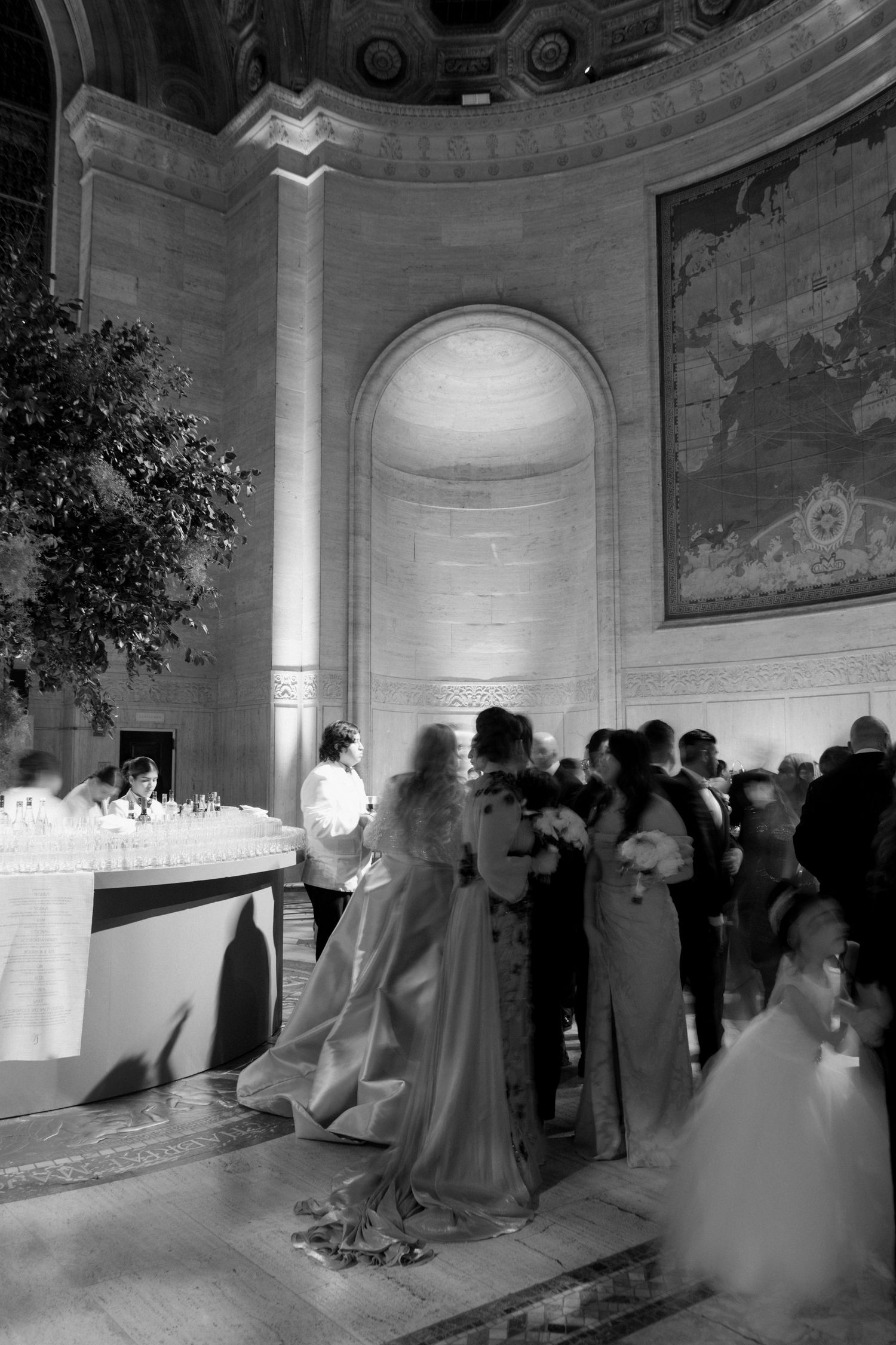 A crowd of people gathered in a grand, ornate hall for a formal event.
