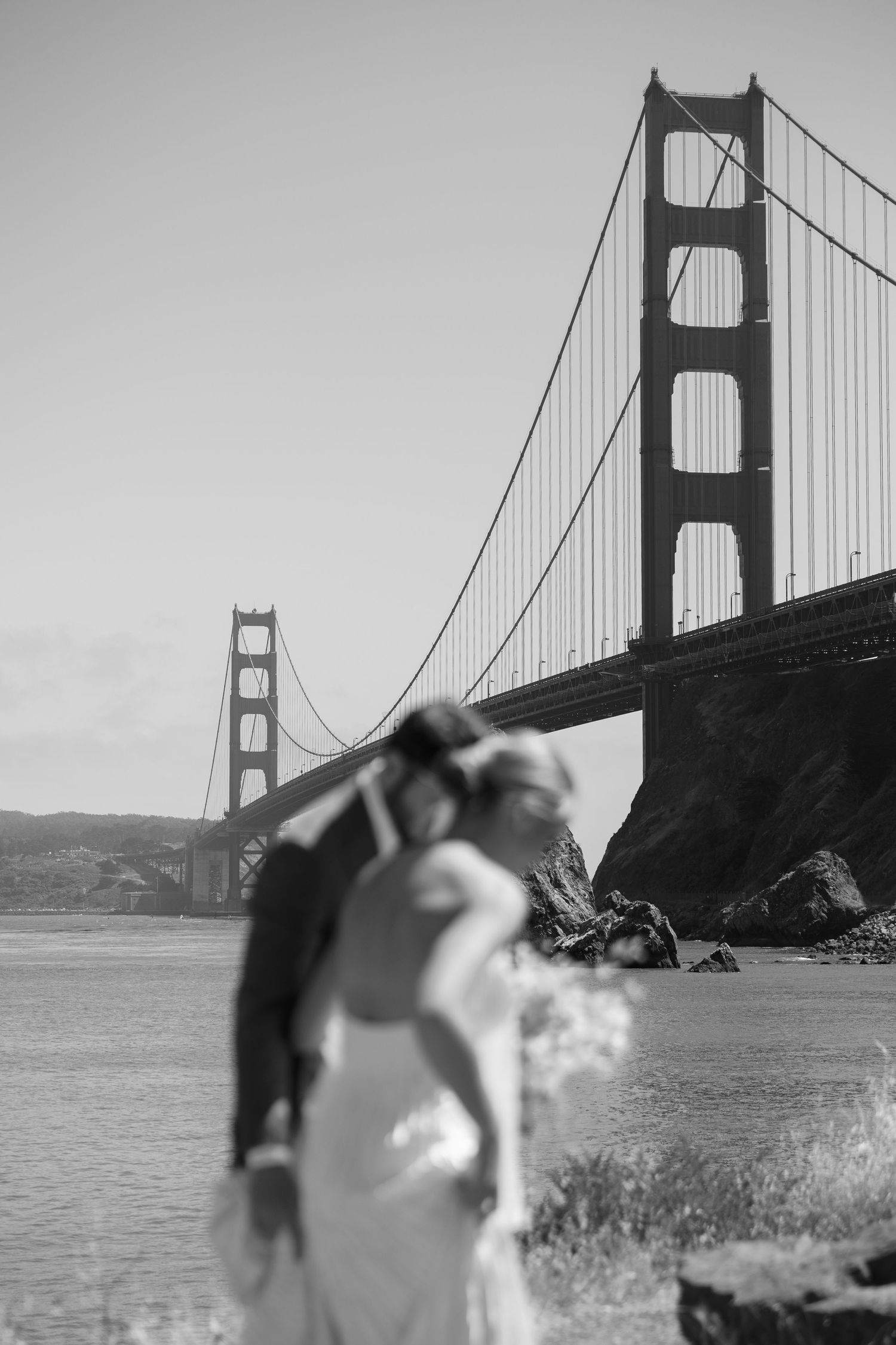 Black and white photo with Golden Gate Bridge in background.