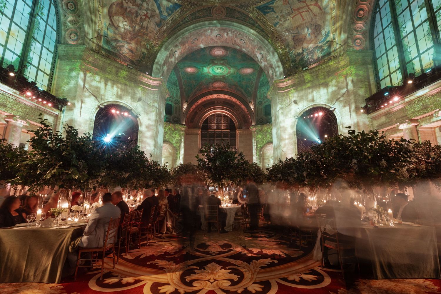 A lavishly decorated banquet hall with an ornate chandelier and intricate architectural details.