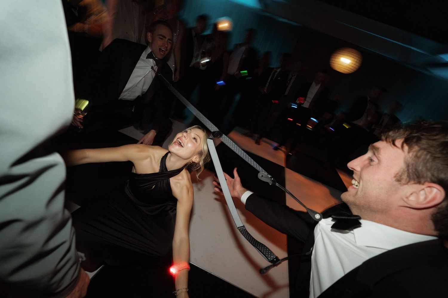 Energetic dance party scene with dynamic movement and blue lighting.