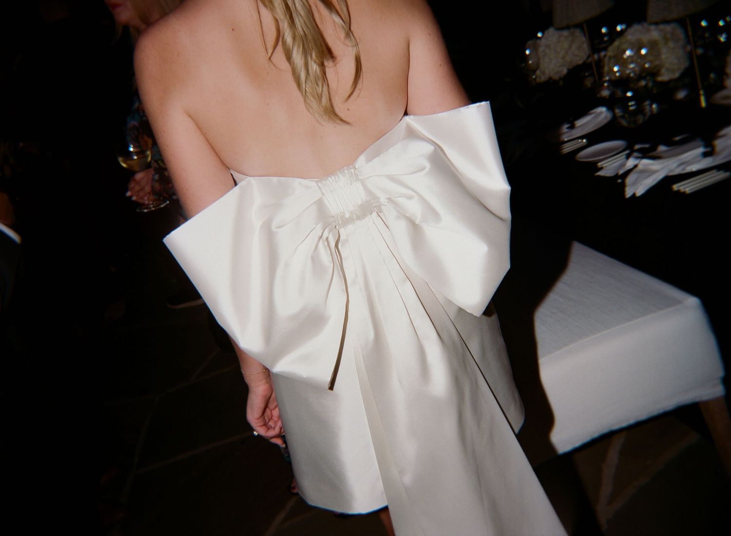 Back view of a white dress with an oversized bow detail.