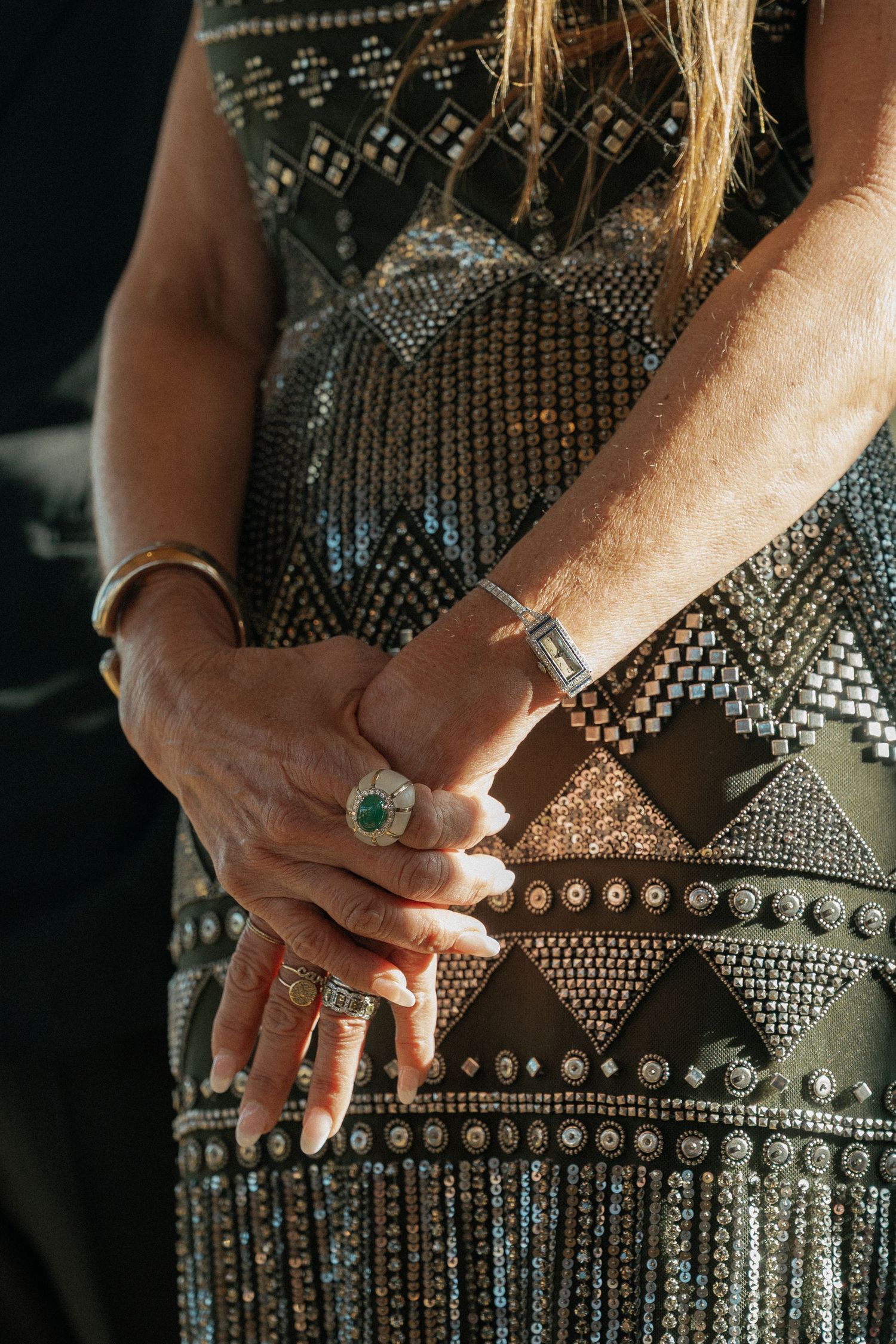 Close-up detail of a beaded dress pattern with geometric designs and sparkles.