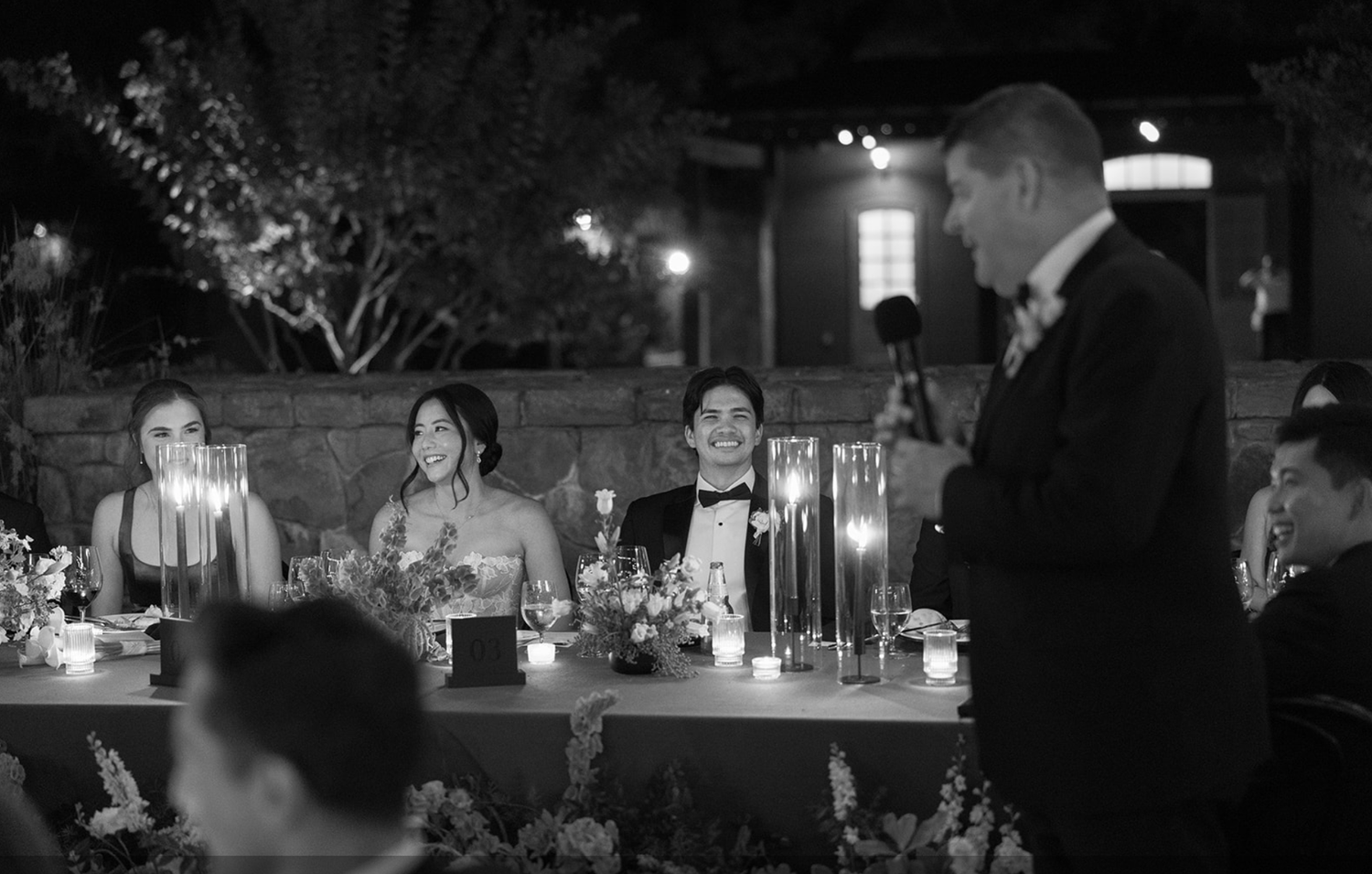 Nighttime wedding reception with ambient lighting and dancing guests.