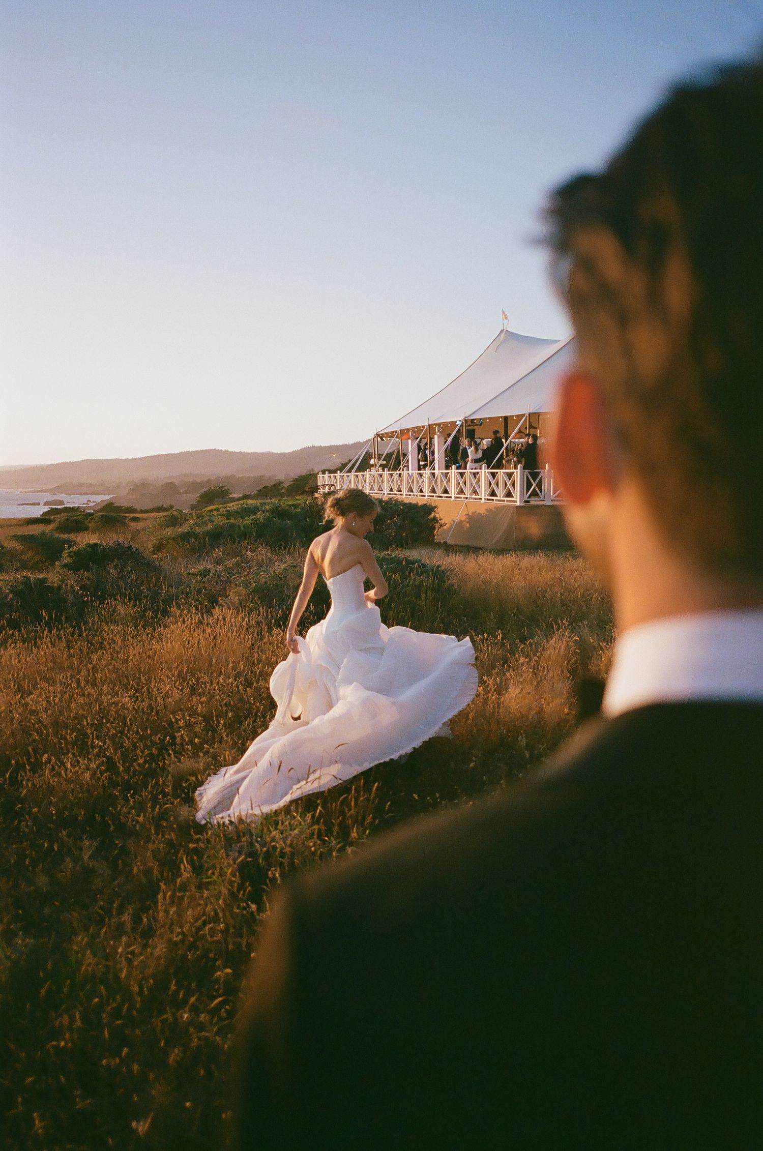 White dress billowing in the wind during a sunset photoshoot.