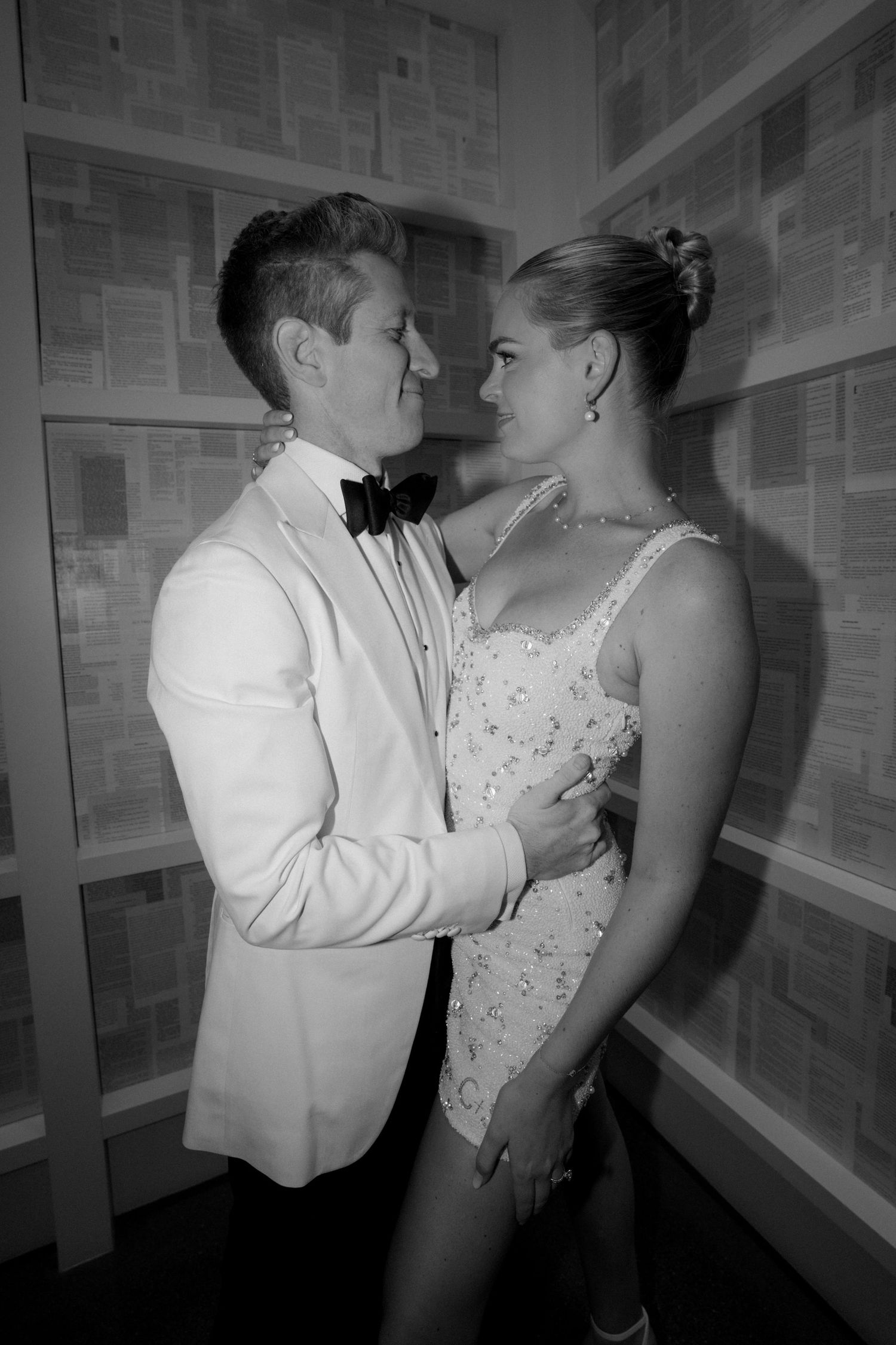 An intimate black and white wedding photo captured in a corridor.