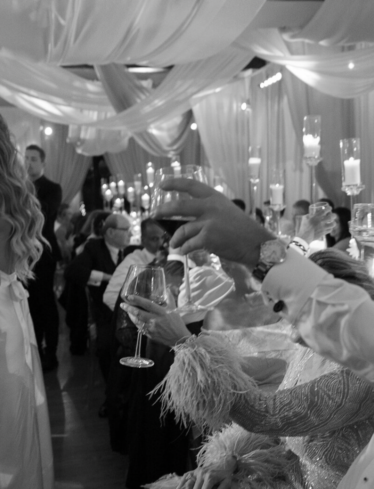 Elegant wedding reception venue with flowing white fabric drapes and decorative lighting.