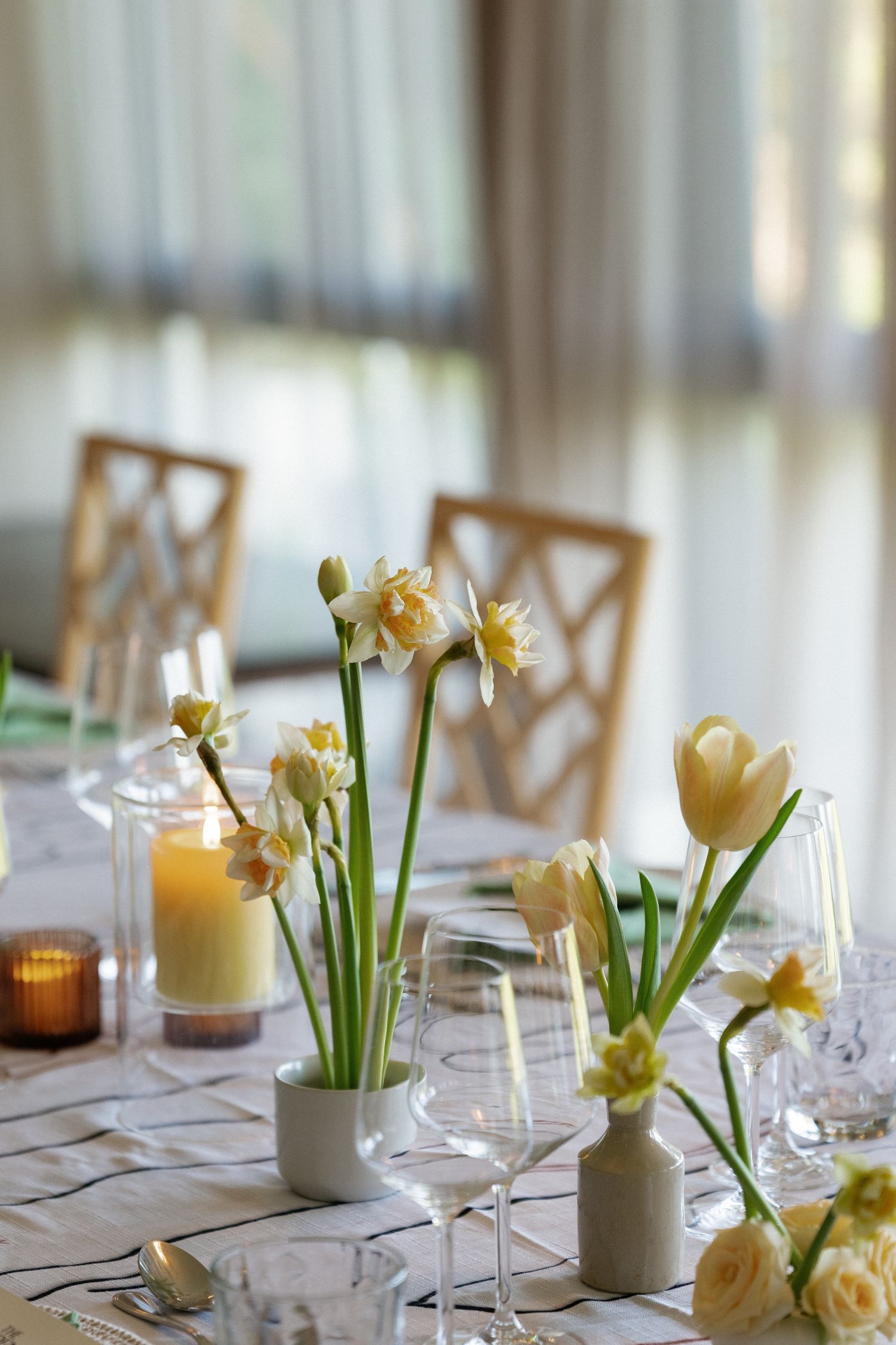 A table setting with flowers, glasses, and other decorations for what seems to be a formal event.