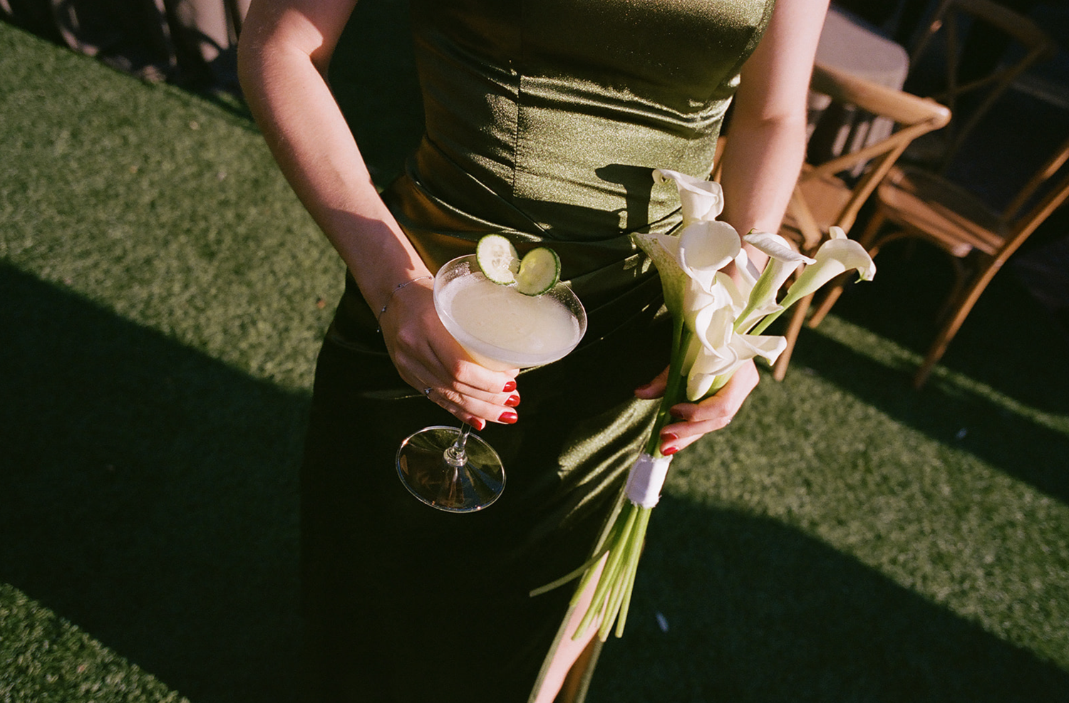 Wedding guests mingling outdoors on a sunny day.