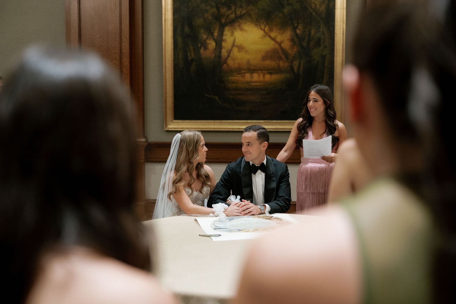 Wedding guests seated at elegant tables during a formal reception.