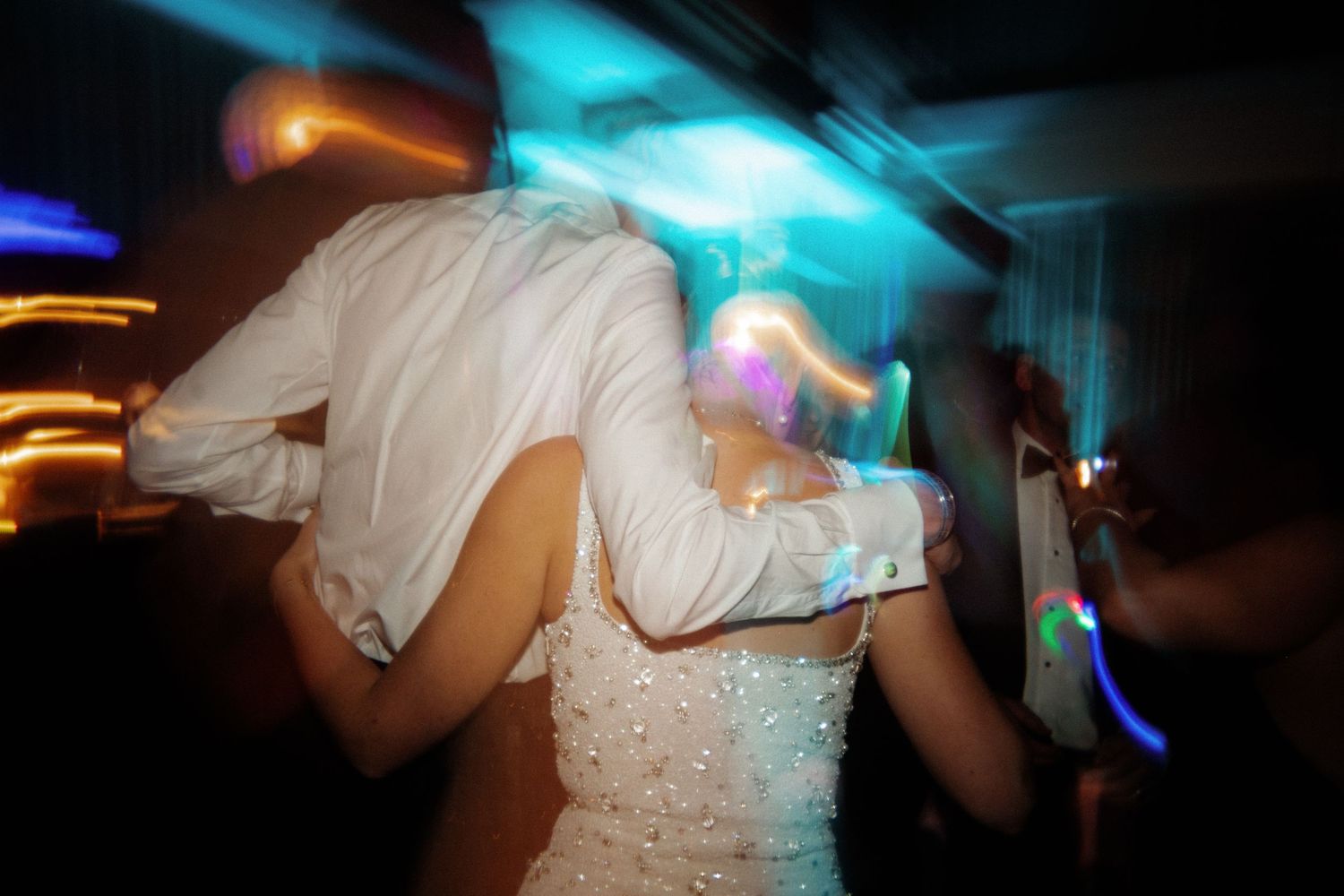 Dynamic dance moves captured with motion blur and blue lighting effects.