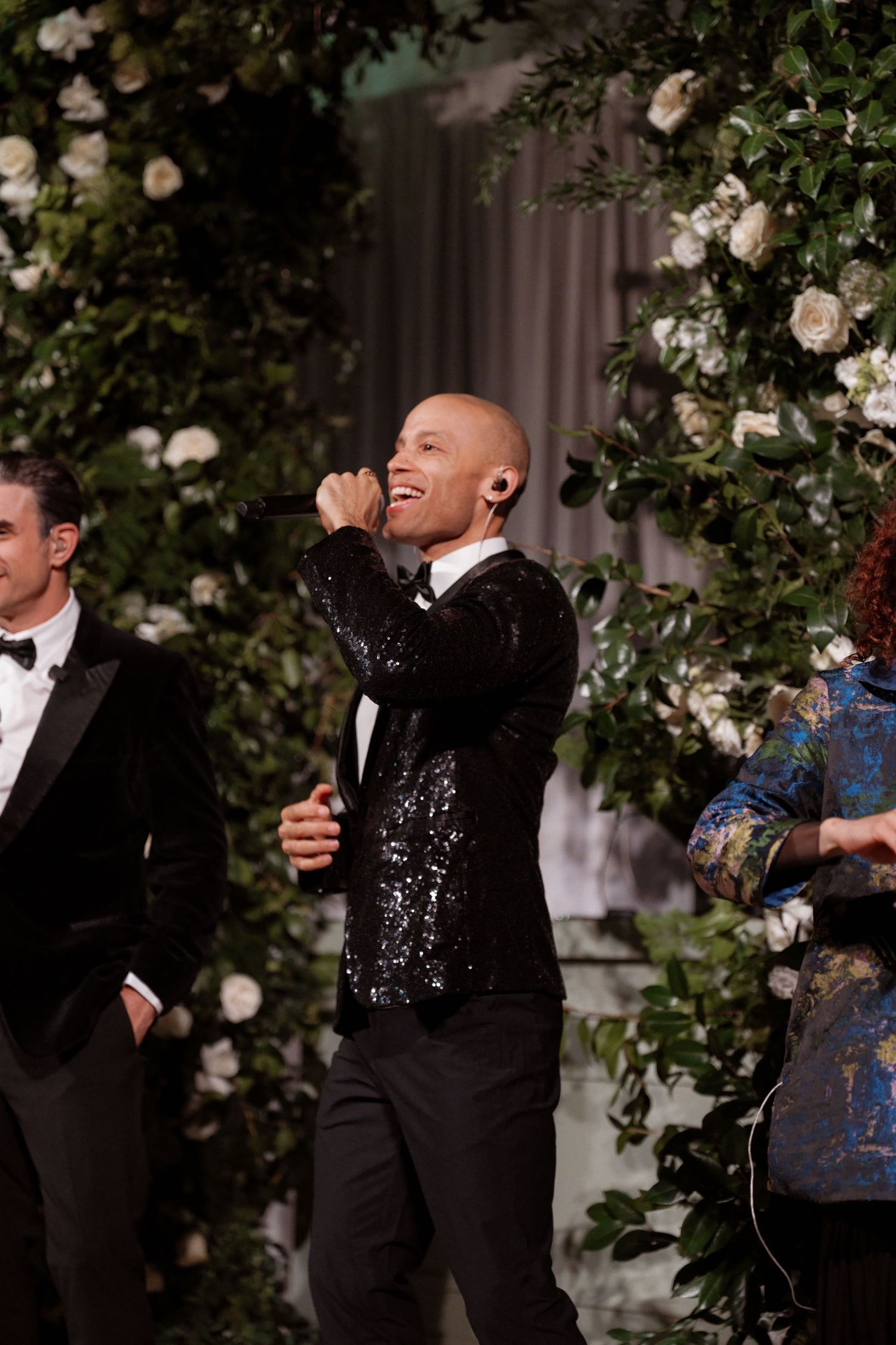 A man in a tuxedo dancing and celebrating at what appears to be a formal event or wedding.
