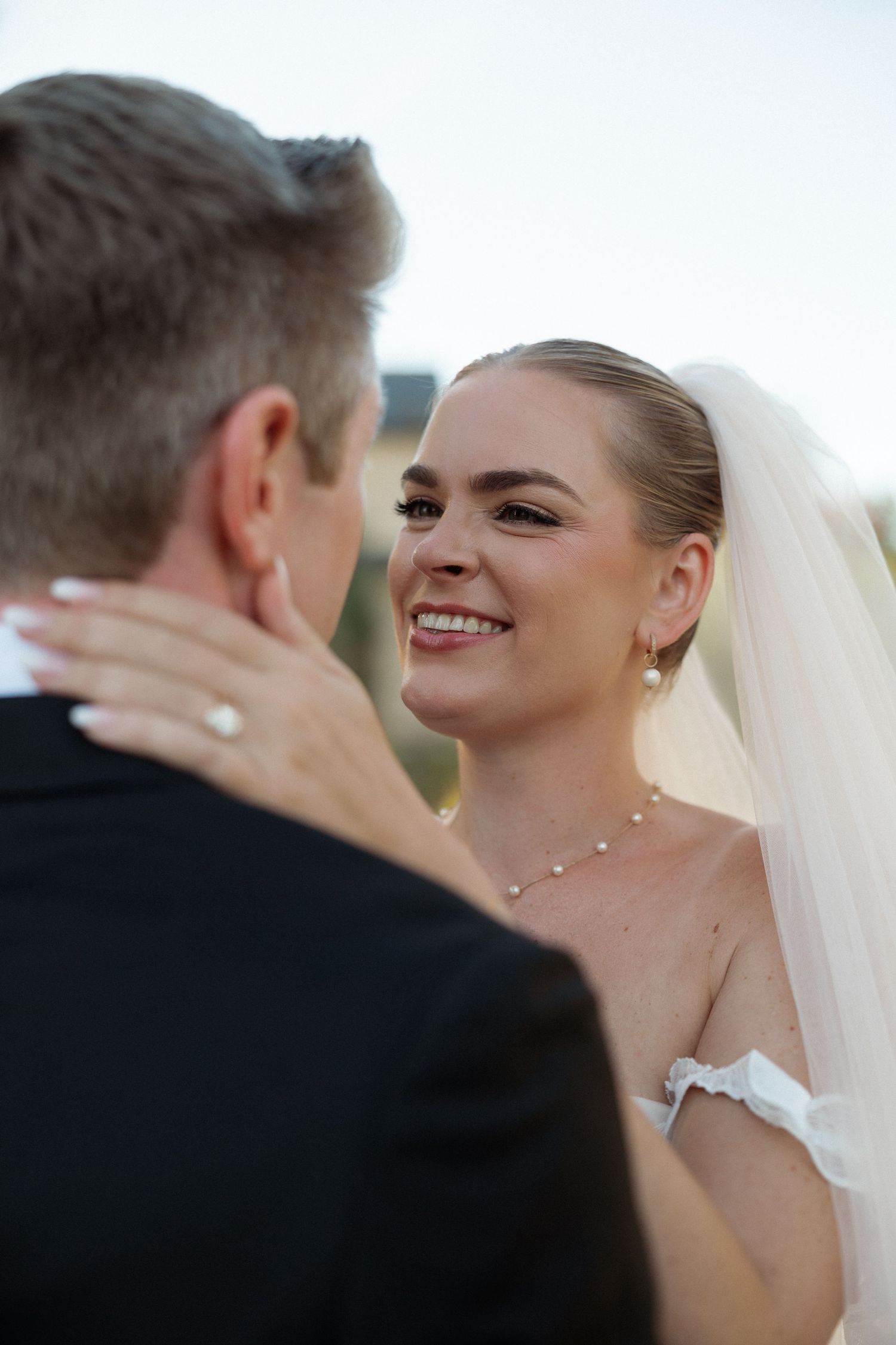 Close-up of a romantic wedding moment outdoors.
