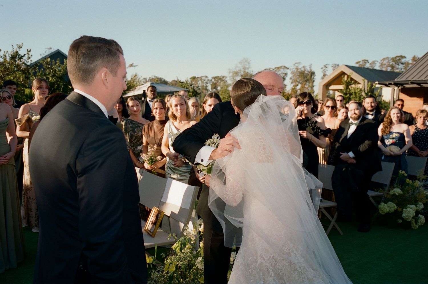 Wedding celebration taking place on an outdoor patio during golden hour.