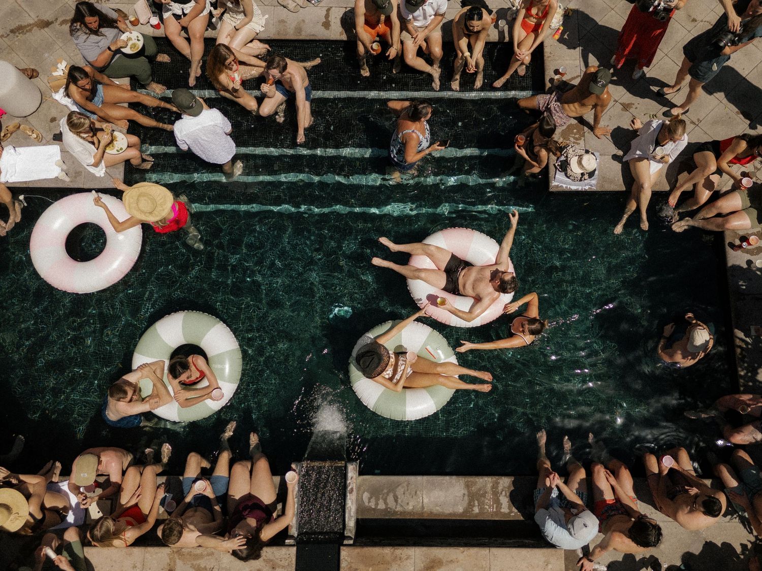 Aerial view of people lounging and relaxing on green steps in an outdoor gathering space.